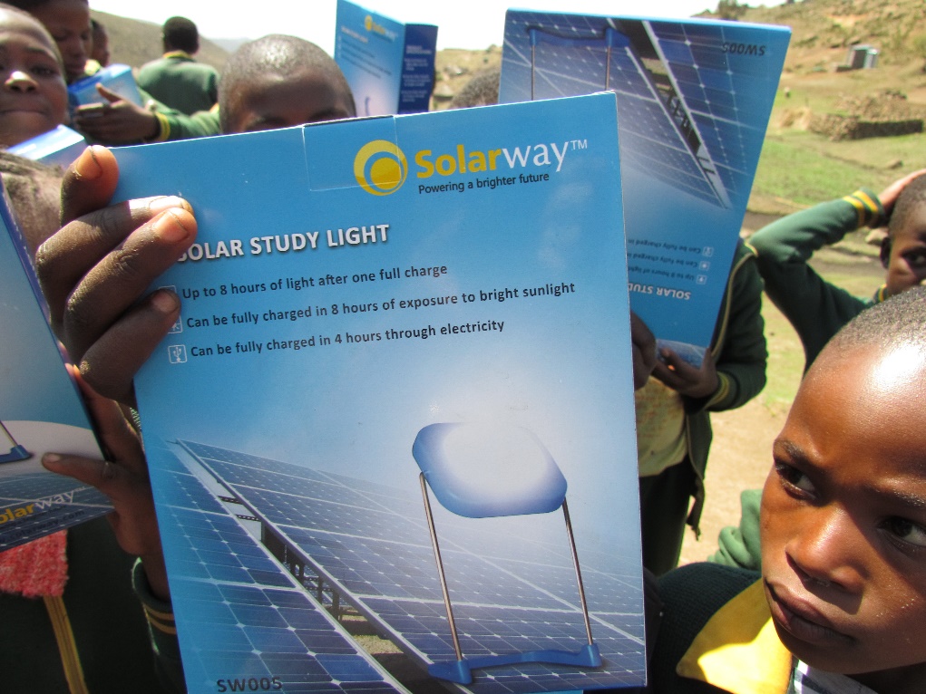 Students holding solar study lights