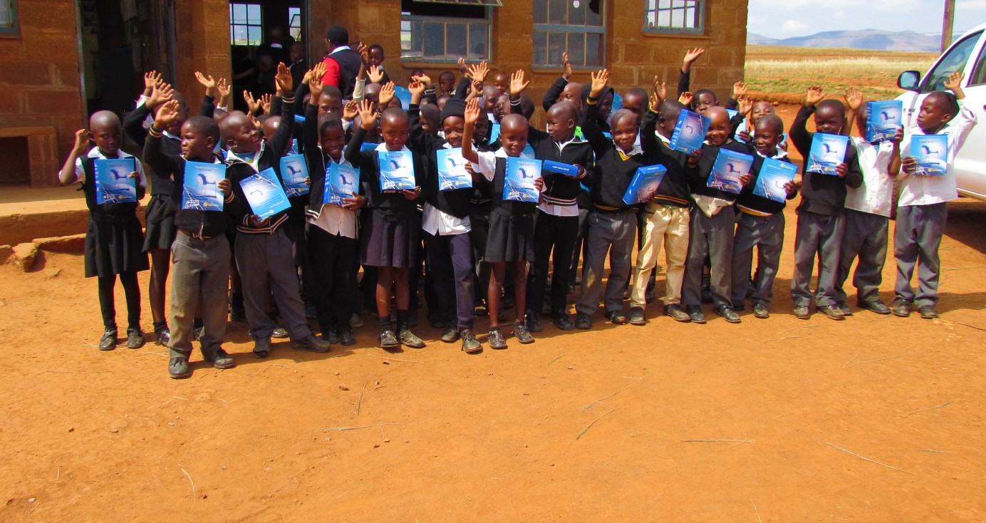 Students displaying solar study lamps