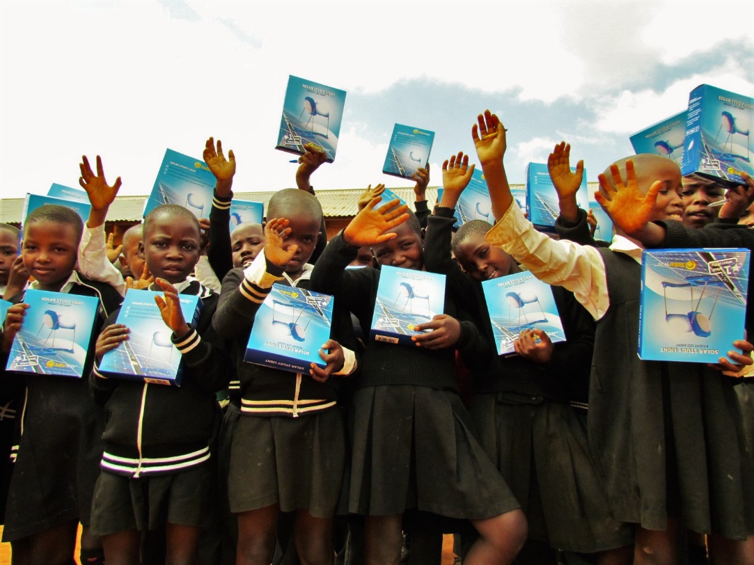 Schoolchildren holding solar lights