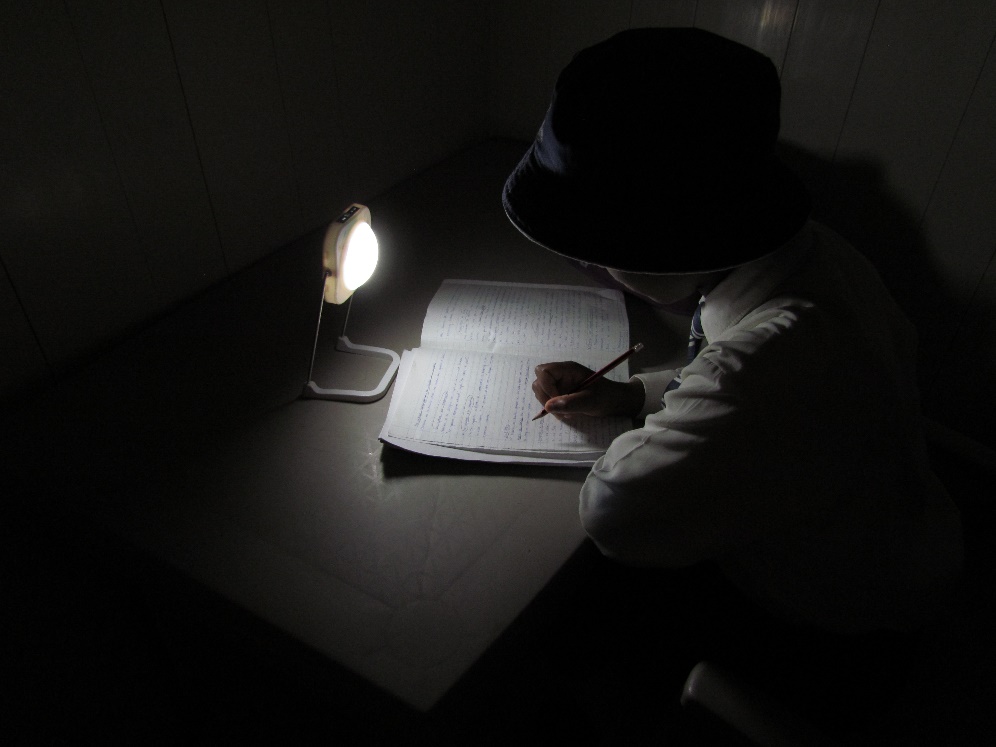 Student using solar light to study at home