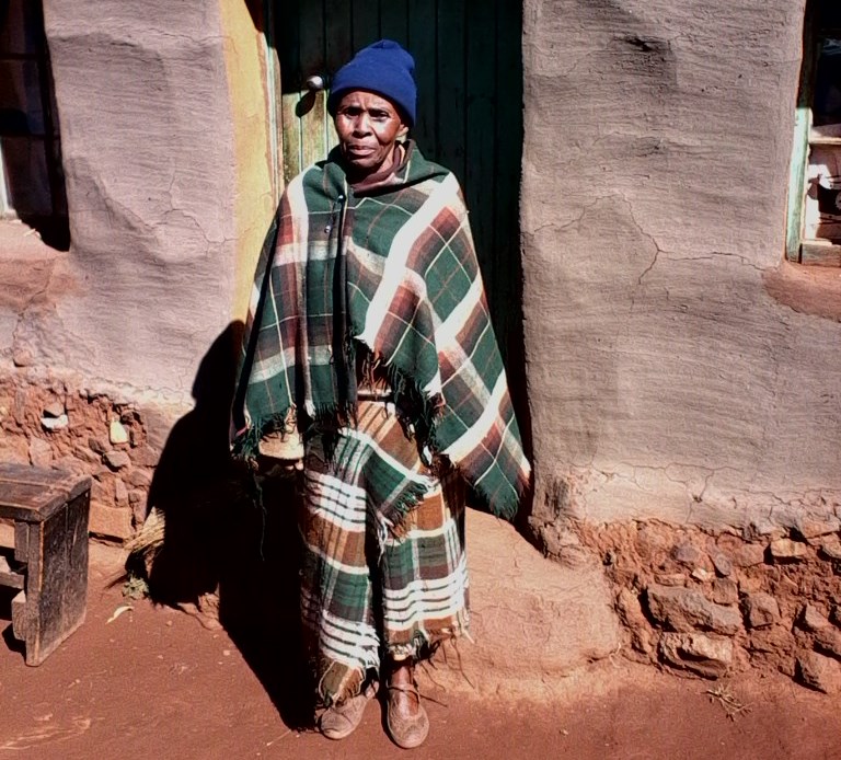 Grandmother standing in doorway in Lesotho