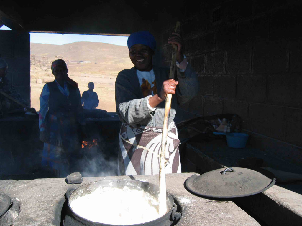Lesotho women cooking Papa in large pot
