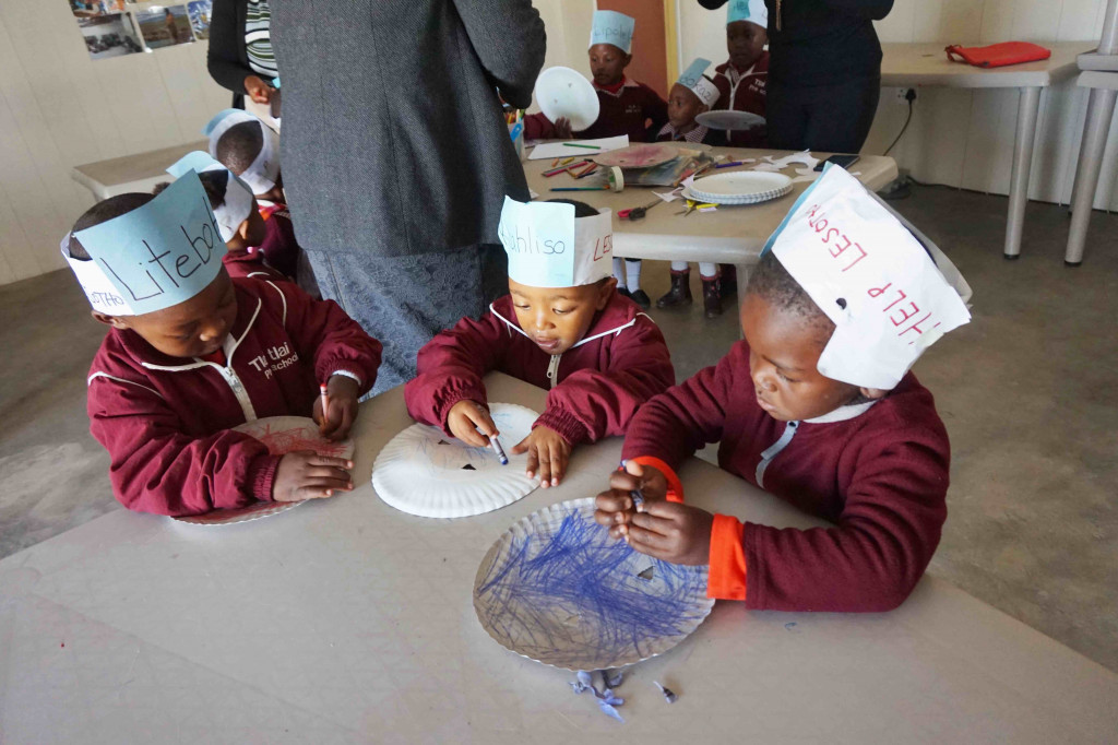 Preschool children in Lesotho doing crafts indoors