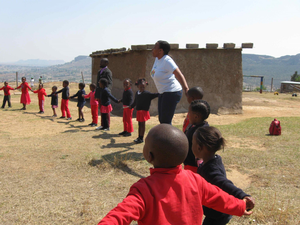 Preschool children in Lesotho playing game outdoor